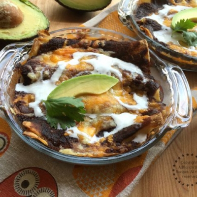 Bean Enchiladas or Enfrijoladas served with cream and avocado