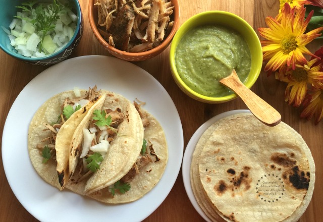 Making delicious Carnitas Tacos with chopped onions, cilantro and serrano guacamole sauce #Porknostico #ad