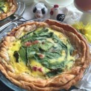 Egg breakfast pie with fresh farm eggs, ham, serrano chile slices, kale and spinach leaves, whole milk and ready to use pie crust