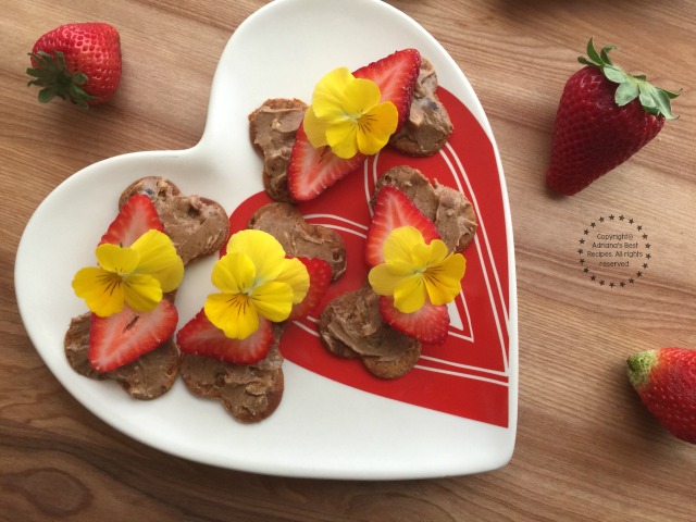 Sweet Bone Treats with almond butter, strawberries and edible pansies
