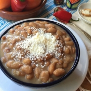 Buttery mayocoba beans garnished with cotija cheese