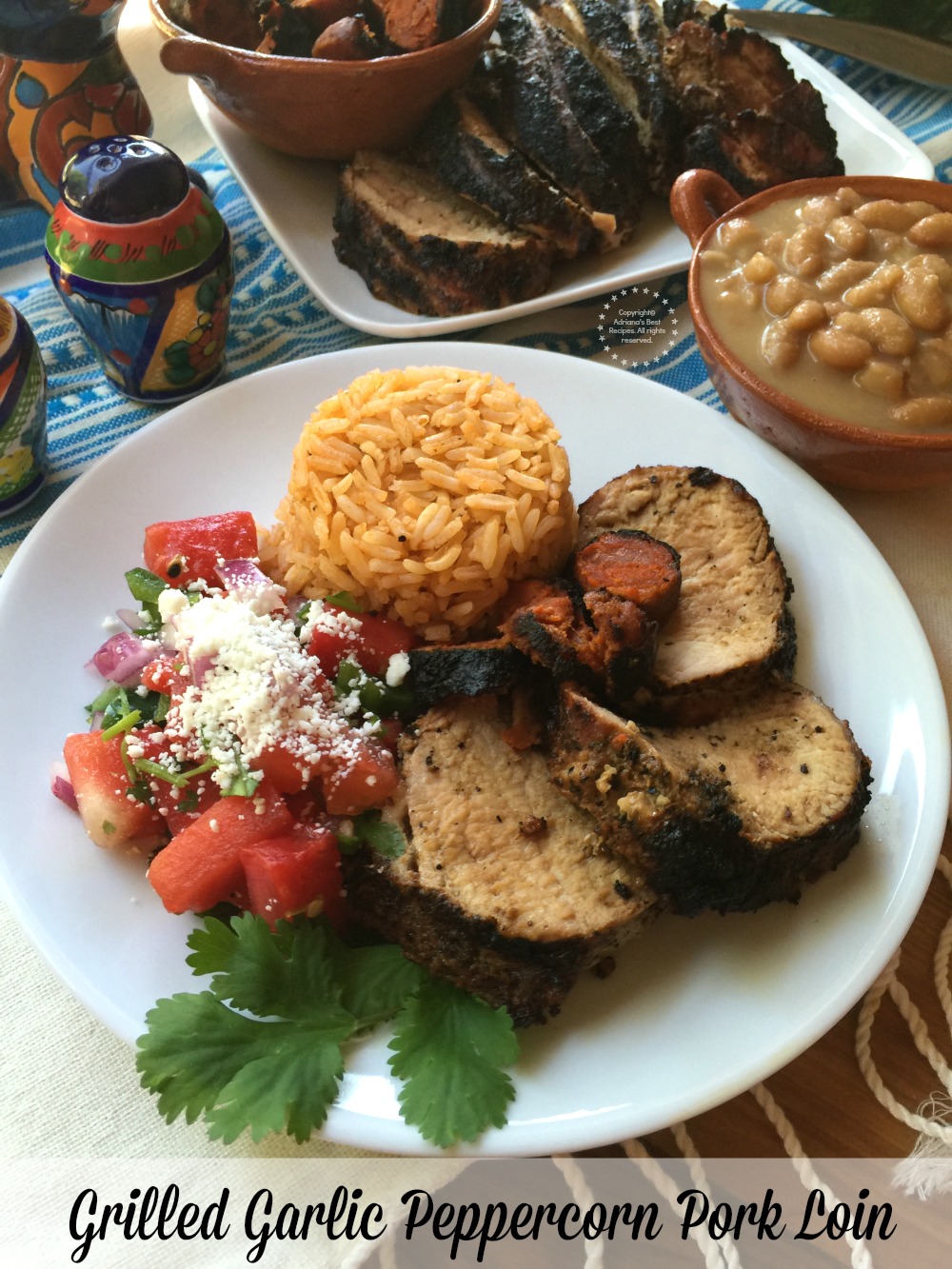 Grilled Garlic Peppercorn Pork Loin paired with Mexican rice, chorizo, grilled watermelon salsa and mayocoba beans