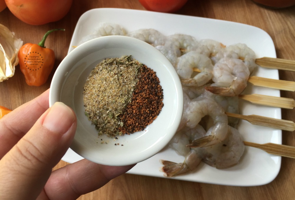 Seasoning the shrimps with sazon latino and hot pepper