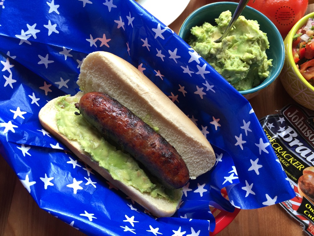 Spread some of the avocado in the butter bun and add the grilled brat
