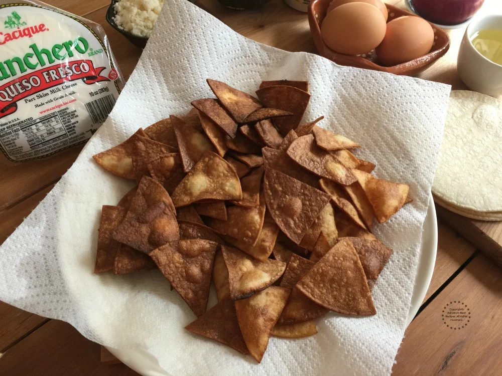 The perfect chilaquiles require homemade totopos The perfect chilaquiles require homemade totopos
