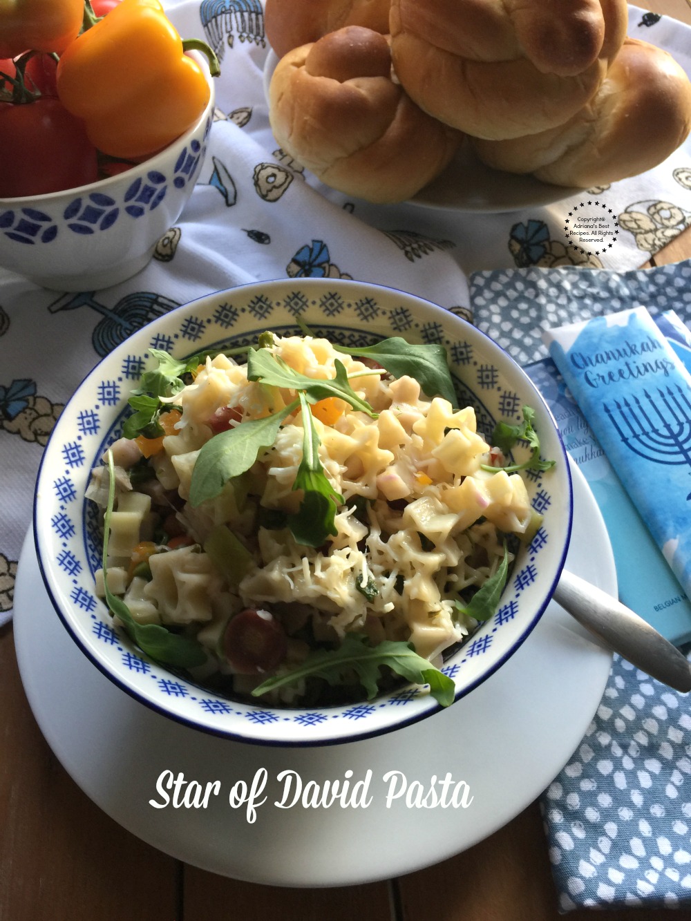 The Star of David Pasta for Hanukkah has tender asparagus arugula rainbow baby carrots and parmesan cheese