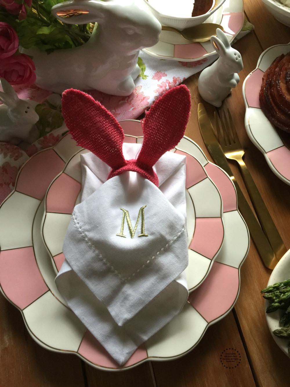 Easter brunch setup includes bunny ears and pink china