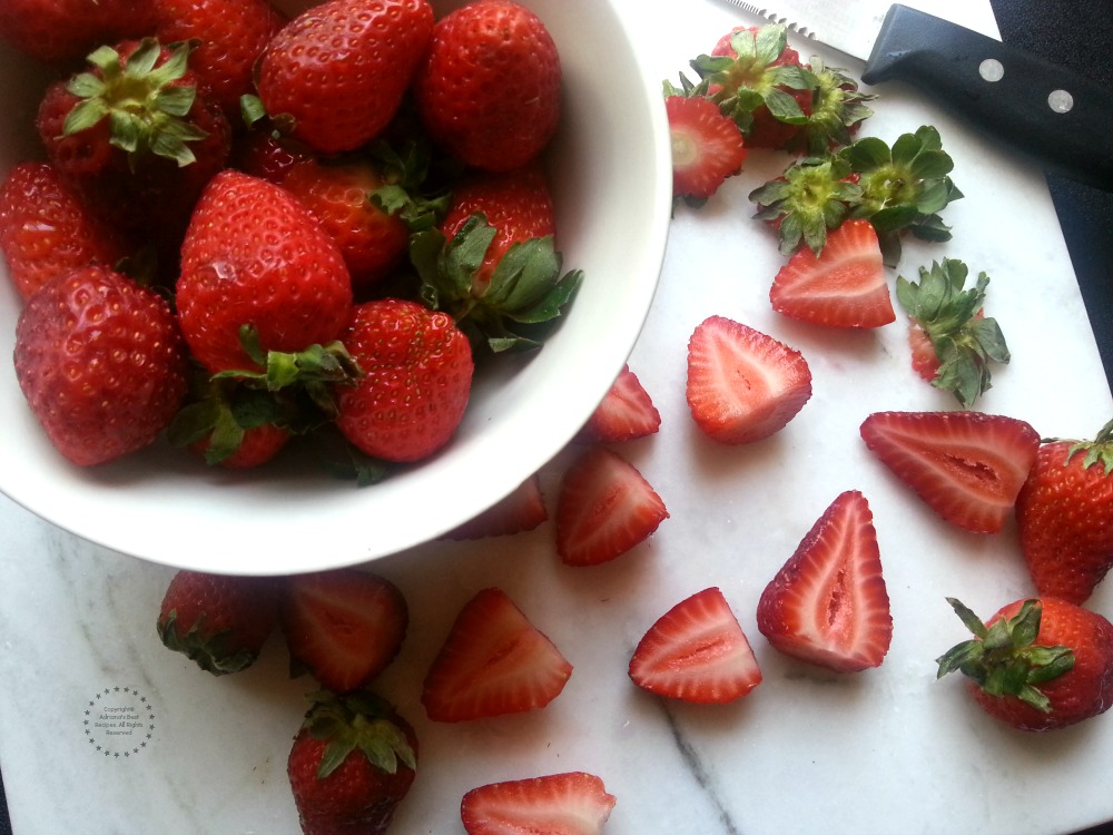 Clean and cut the strawberries in halves