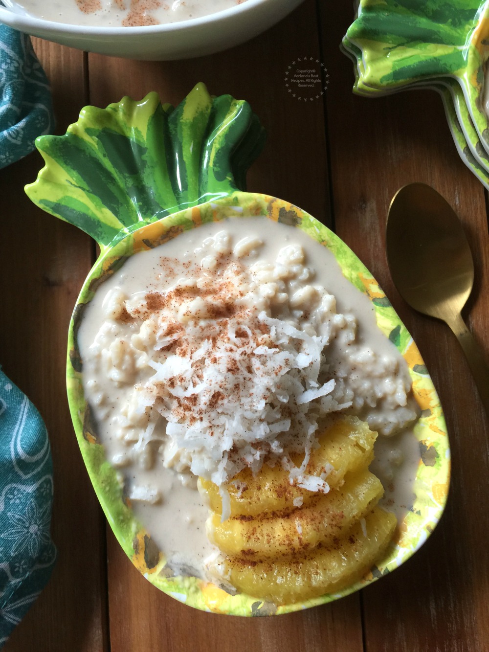 Rice pudding topped with slices of pineapple and shredded coconut  