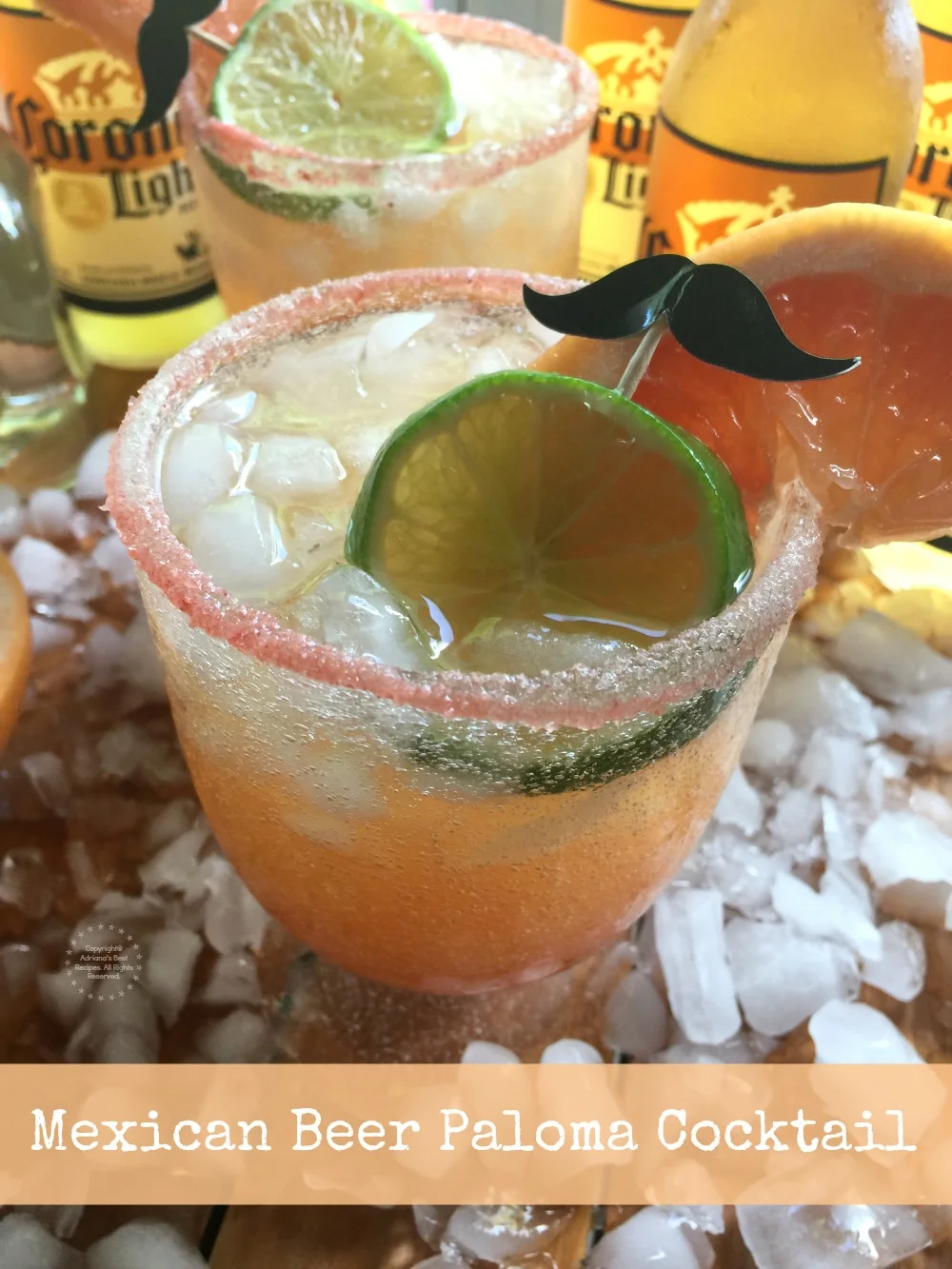 This Mexican Beer Paloma Cocktail has grapefruit juice, crushed ice, Casa Noble tequila blanco, pink salt, liquid chamoy, lime, grapefruit slices and Corona Light
