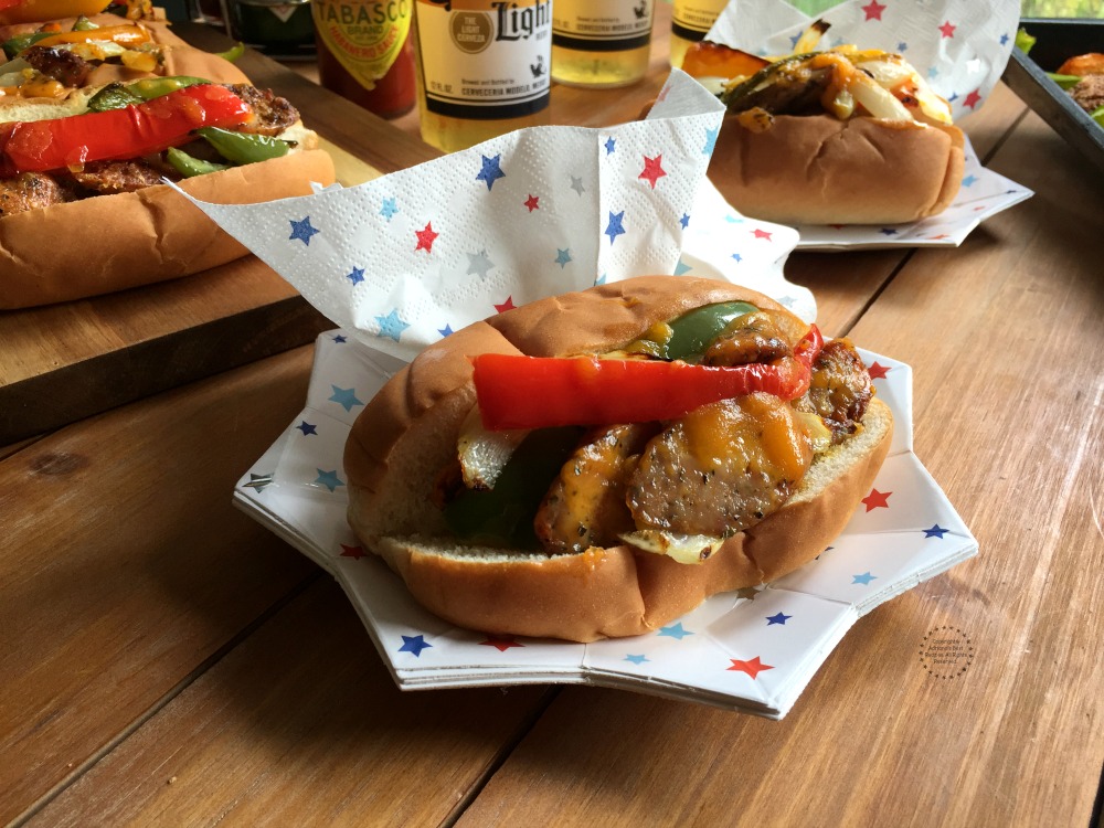 Patriotic Chicken Fajita Hot Dogs with chicken sausage, cheese, and peppers. Served on a decorative star shaped plate and napkins with printed stars.