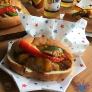 Chicken fajita hot dogs served on a patriotic star plate paired with beer