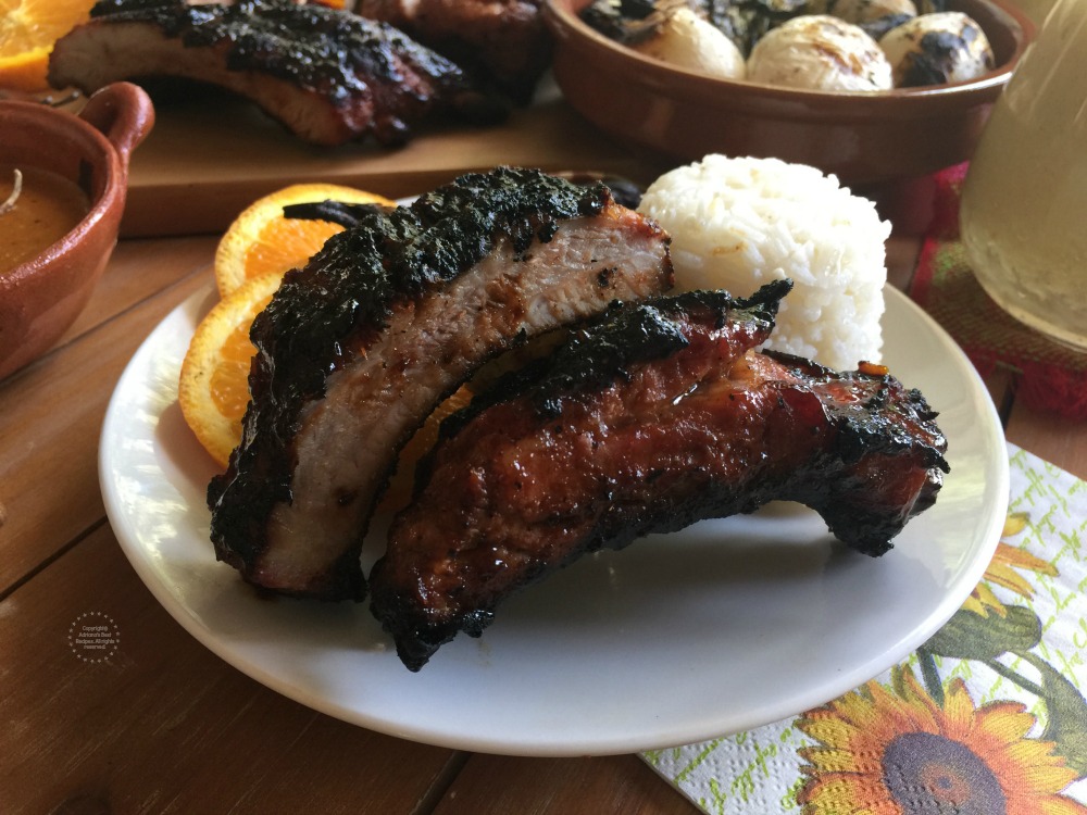 A plate showing two pork ribs grilled and BBQ