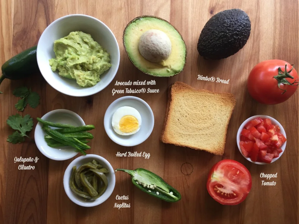 avocado mash, tomato, toast, jalapeno, cilantro and cactus on a table