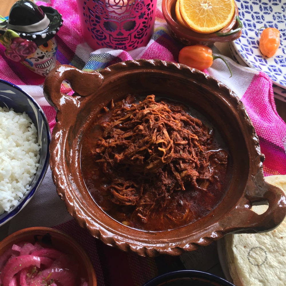 a clay pot with shredded meat