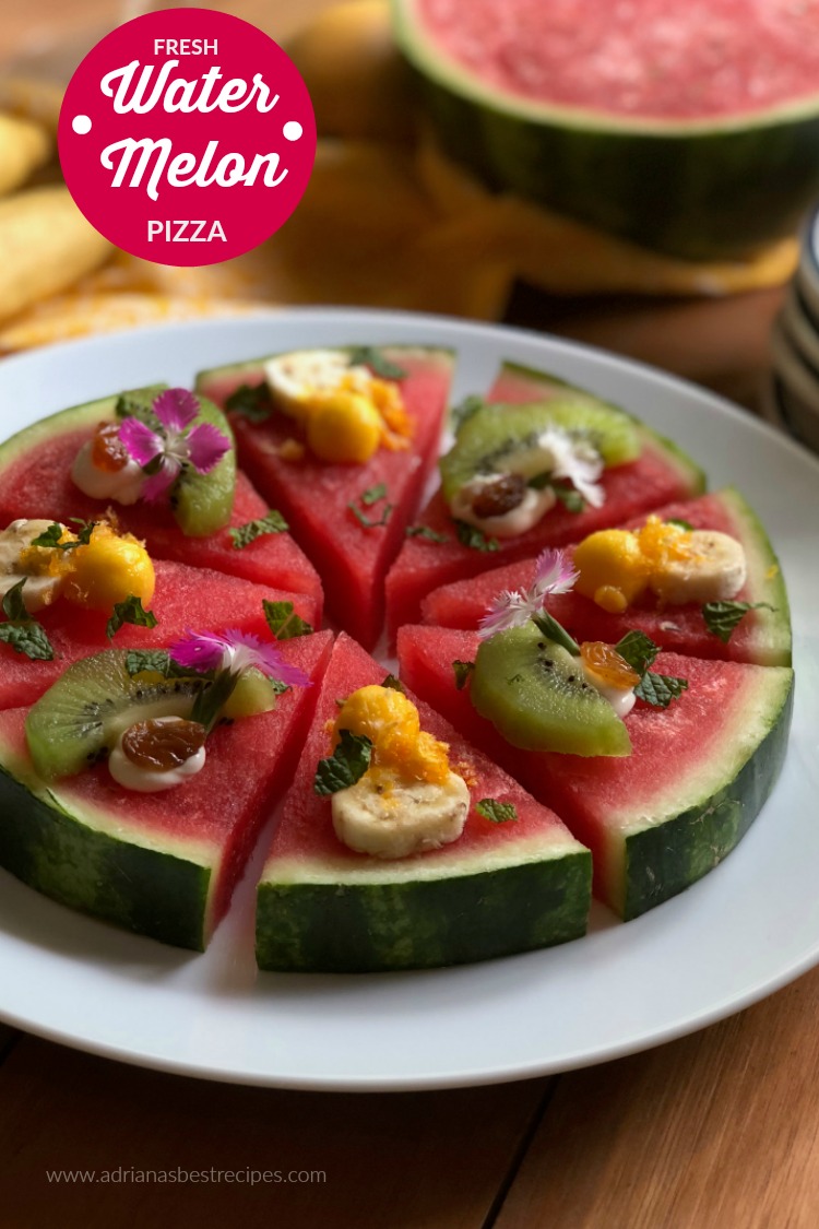Let the pizza party start making a fresh watermelon pizza, made with a sweet petite watermelon round thick slice, soft cream cheese, green kiwi fruit, champagne mango pearls, Manzano banana rounds, fresh mint, golden raisins, tangerine crisps and edible carnation flowers.