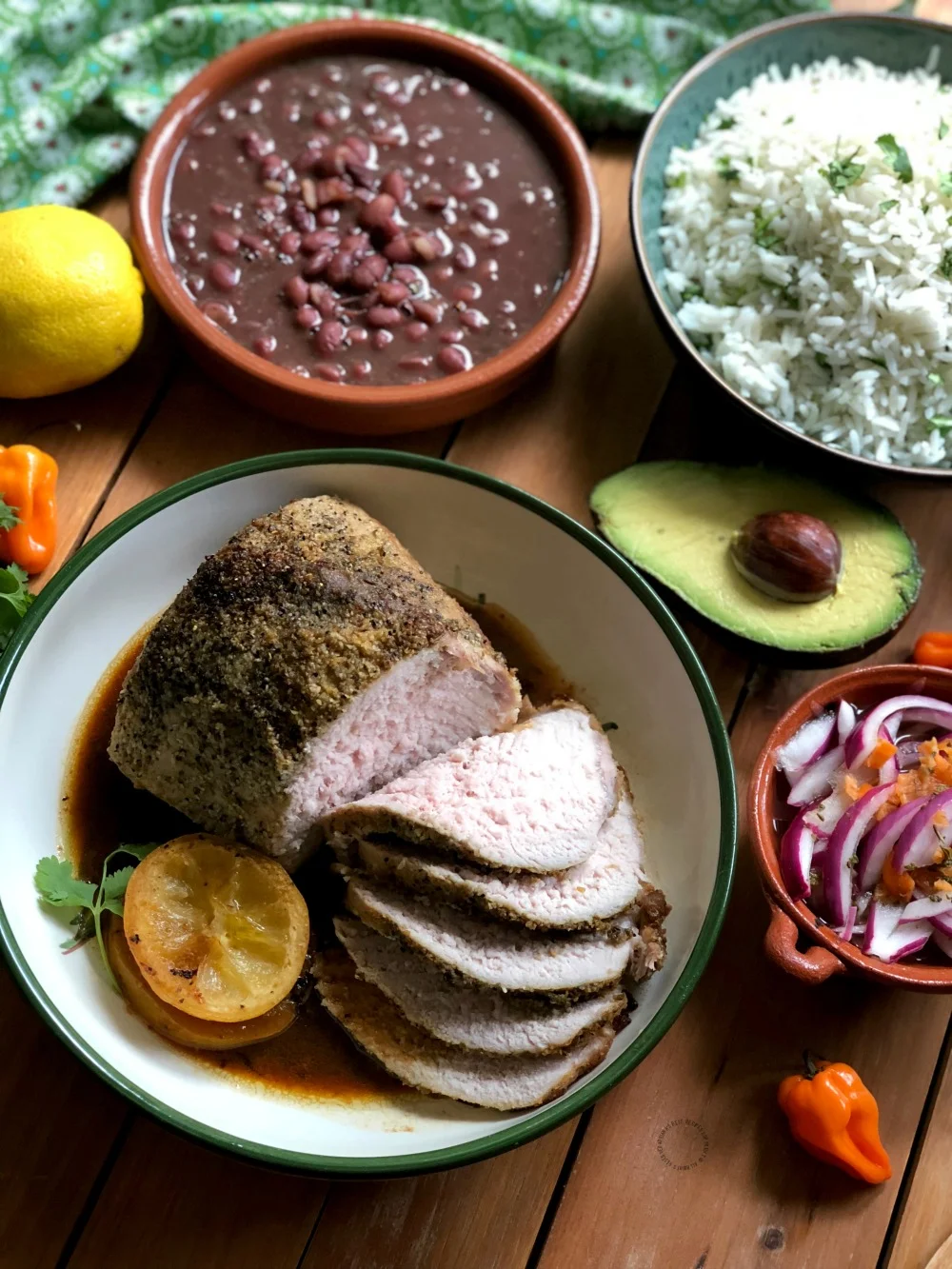 Serving the tequila lemon roasted pork loin with all the fixings Serving the tequila lemon roasted pork loin with all the fixings