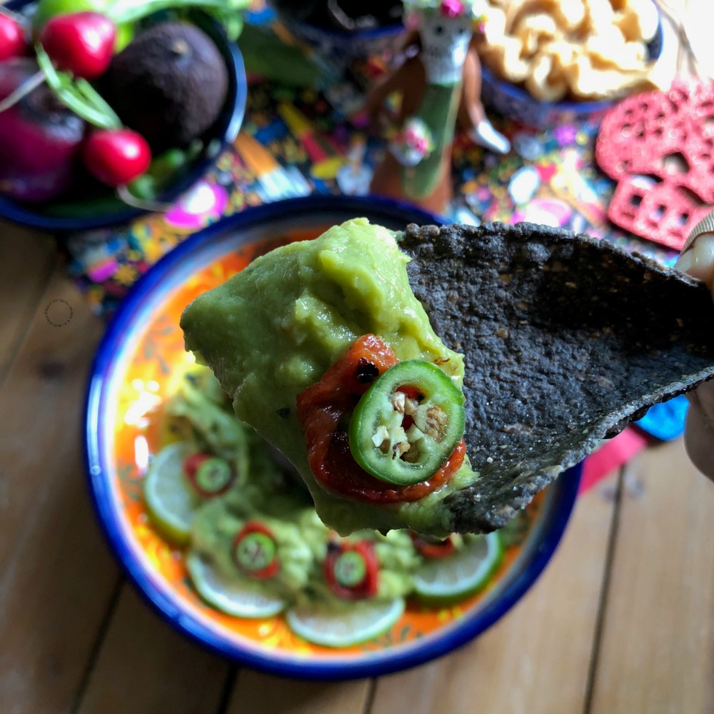 a tortilla chip with avocado mash