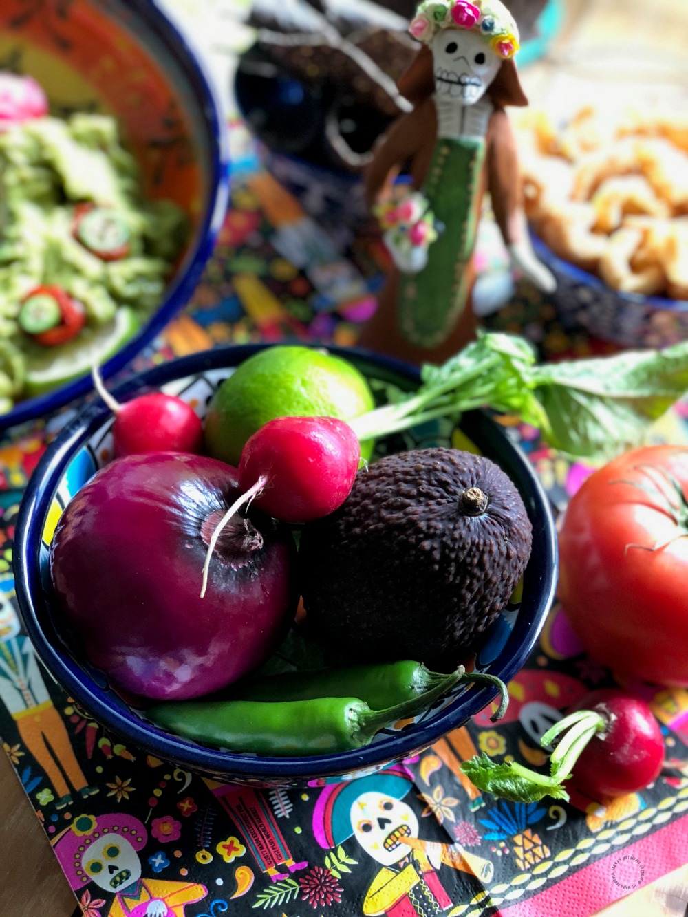 a bowl with produce such as purple onions and peppers