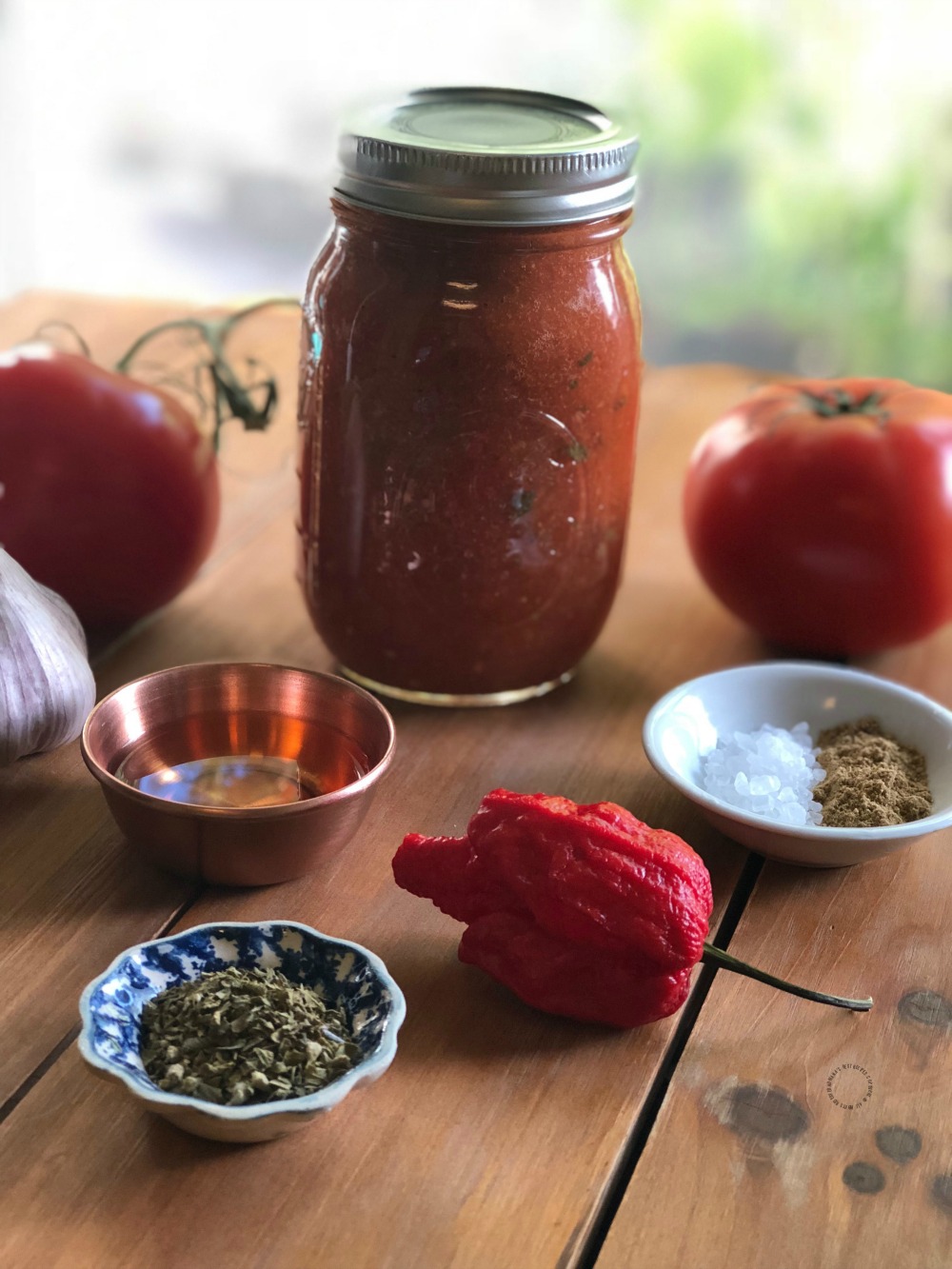 a mason jar with hot pepper sauce
