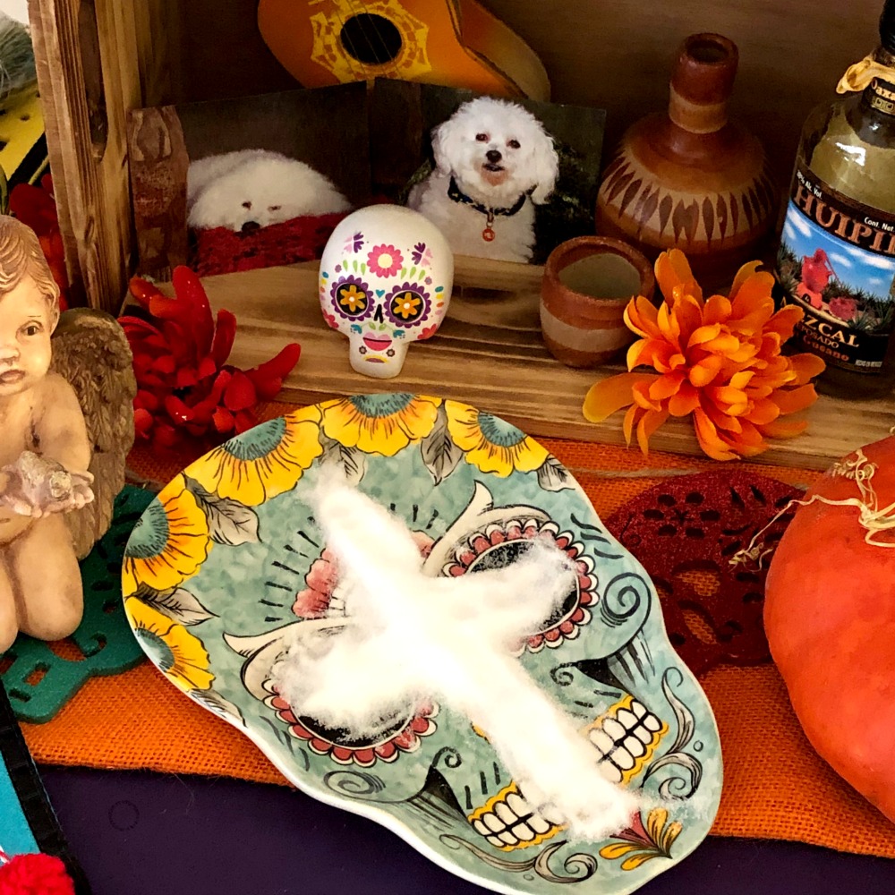 A cross made of salt, mezcal and our departed pets are also part of the altar