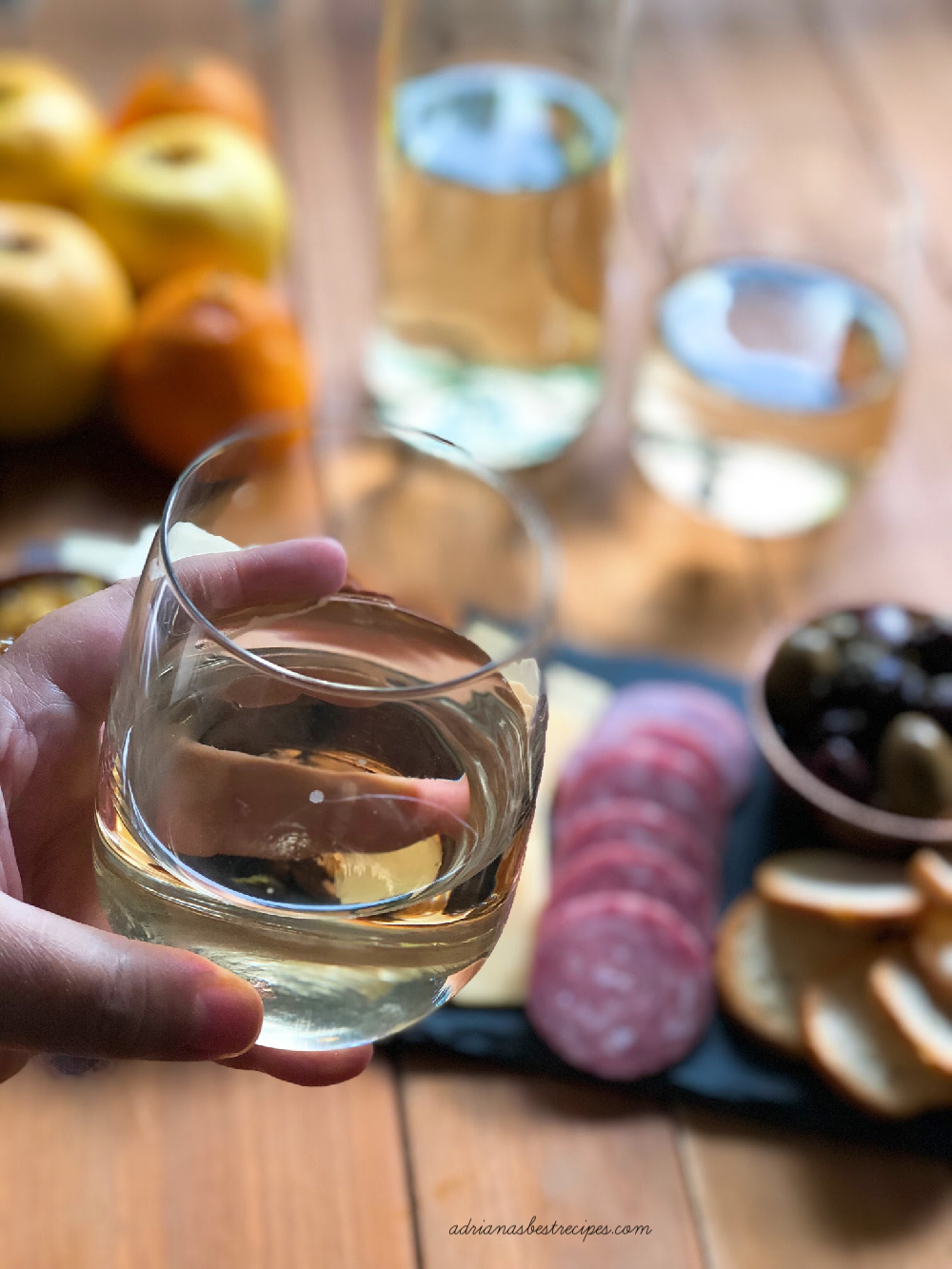 A hand holding a wine glass.  