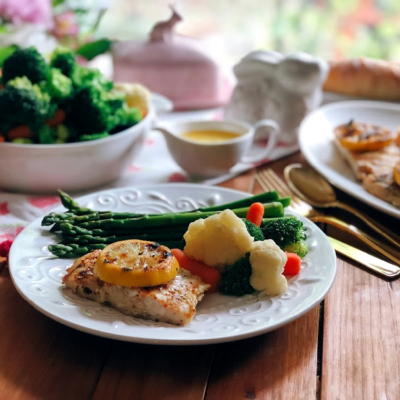 Grilled Pacific Snapper Recipe served with a side of veggies, asparagus, and a French style butter sauce