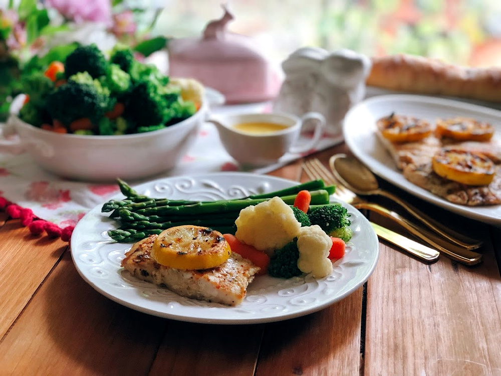 Grilled Pacific Snapper Recipe served with a side of veggies, asparagus, and a French style butter sauce