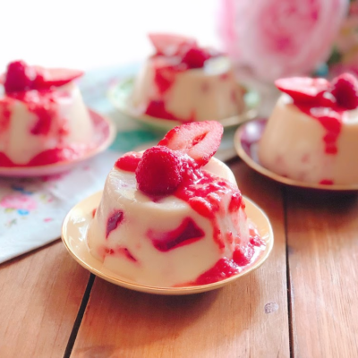 Strawberry Mosaic Mexican Jello Dessert made with strawberry and milk jello and garnished with a strawberry sauce and fresh berries