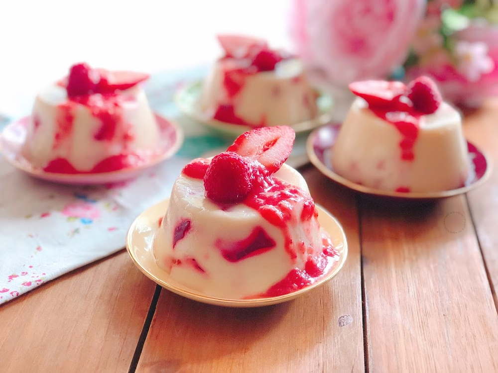 Strawberry Mosaic Mexican Jello Dessert made with strawberry and milk jello and garnished with a strawberry sauce and fresh berries