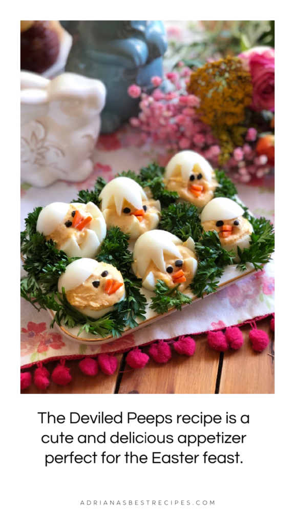 The Deviled Peeps recipe is a cute and delicious appetizer perfect for the Easter feast. This recipe has white eggs, mayo, mustard, and spices — carrots for the beaks and black olives for the eyes. Nesting on a plate garnished with curly parsley. 