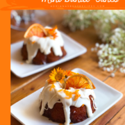 The Cara Cara orange mini bundt cakes have real citrus juice, cream cheese frosting, a fresh glaze made with orange peels and juice, and garnished with beautiful edible flowers and dehydrated orange slices.