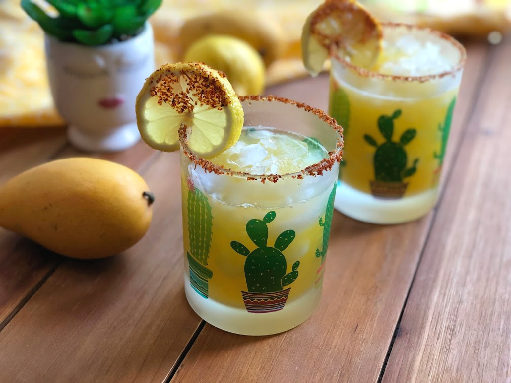 Cheers to a tasty and spicy manila mango mocktail or agua fresca with fresh mango, lemon, sugar, fresh water, and chamoy