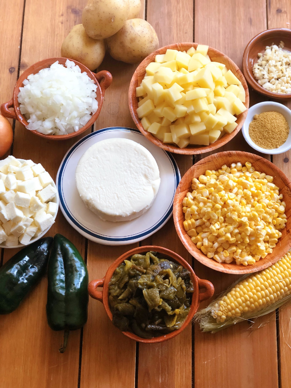 The ingredients for the soup include potatoes, corn, onion, garlic, queso fresco, roasted poblanos, milk, and seasonings