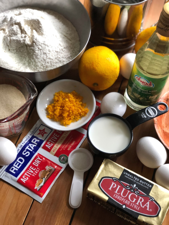 Ingredients for making pan de muerto inlcude sifted flour, eggs, yeast, orange peel, sugar, butter, and orange blossom water. 
