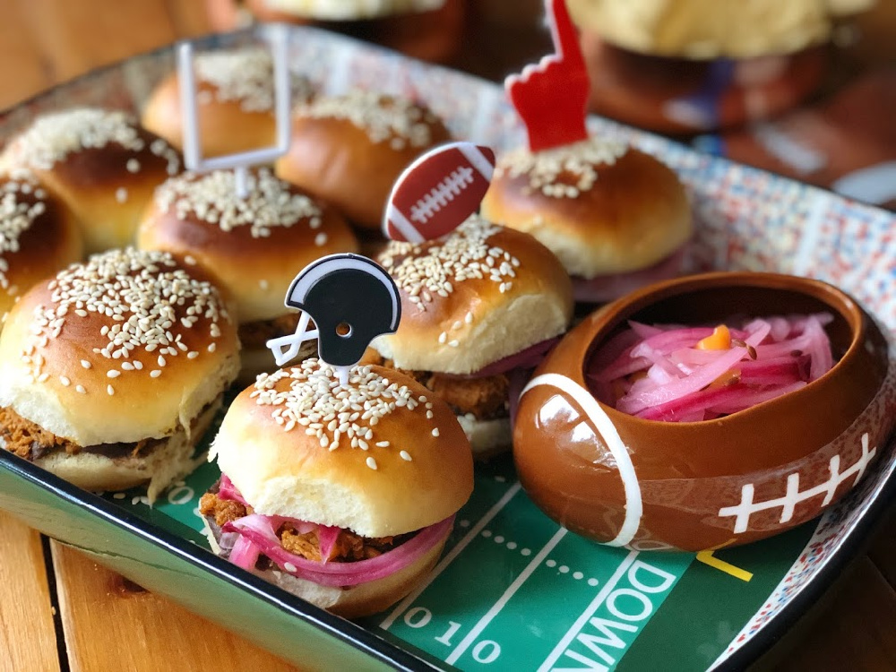 This are the BBQ Pork Pibil Sliders with Refried Beans served on a football themed tray with decorative pins