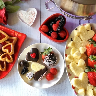 This is the Chocolate Fondue Party for Chocolate Month. It has a plate with cake hearts, marshmallows, and assorted berries.