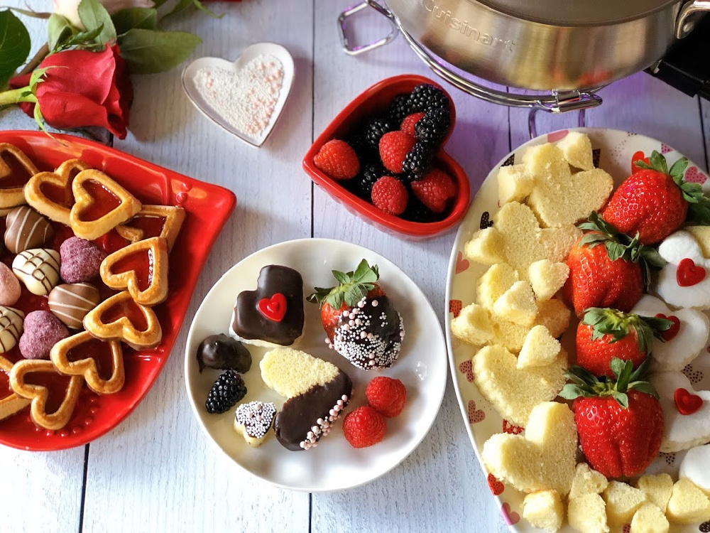 This is the Chocolate Fondue Party for Chocolate Month. It has a plate with cake hearts, marshmallows, and assorted berries.