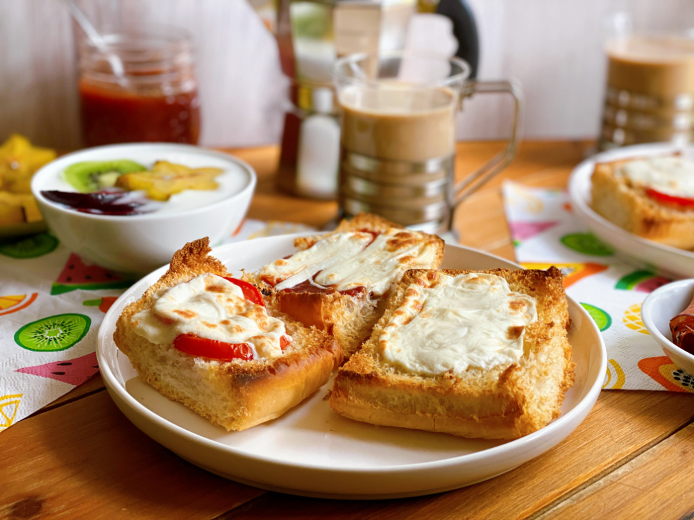 a plate with toast and in the background coffee and milk