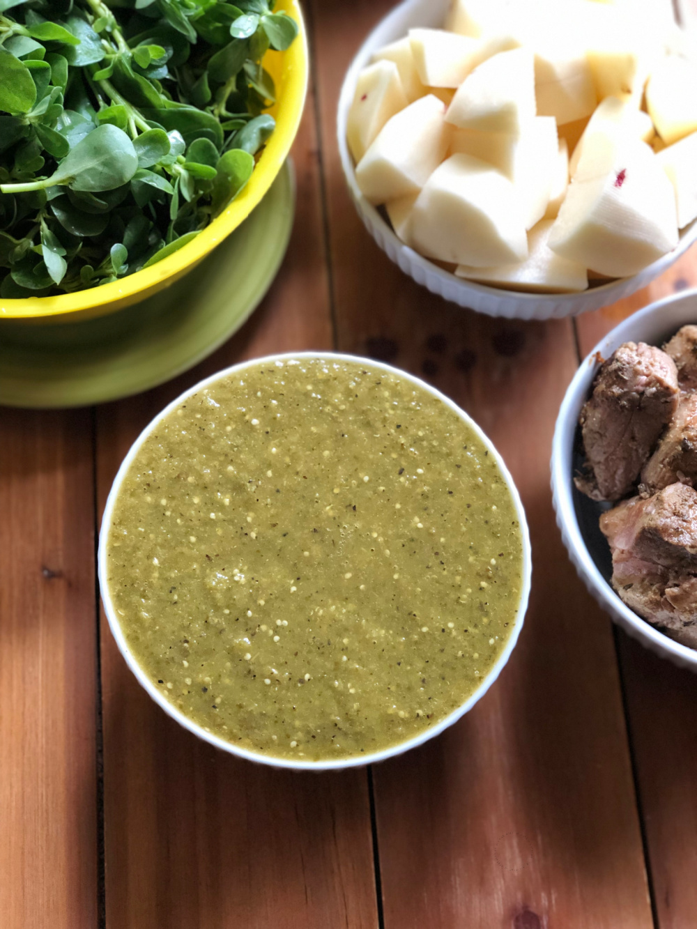 a bowl of green tomatillo sauce