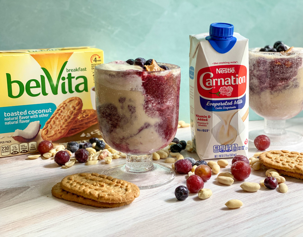 Showing a glass with a milk beverage and cookies. 