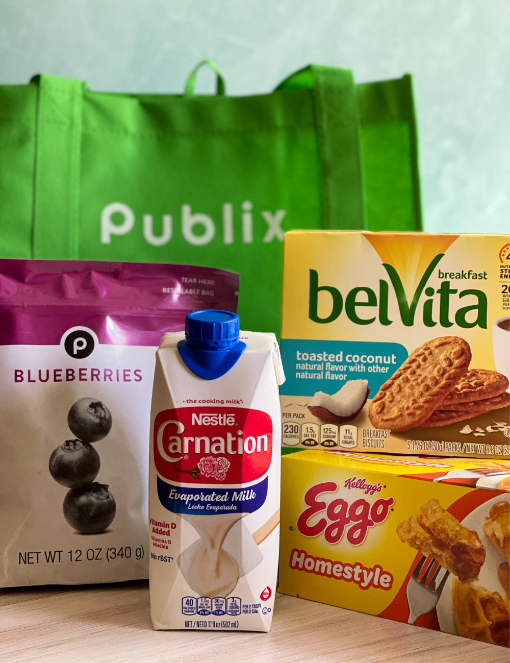 An image showing several products including carnation milk, Publix frozen blueberries, Belvita cookies, and Eggo waffles.