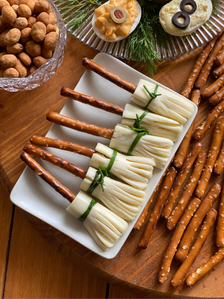 a board with pretzels and cheese for making witch themed food