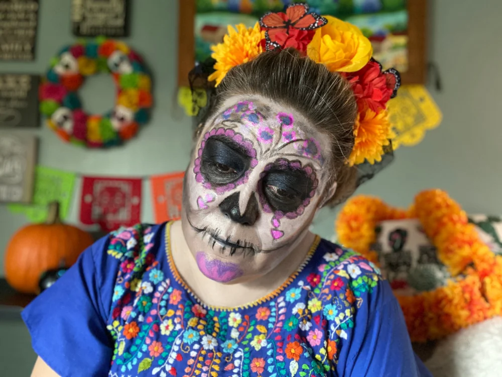 a picture of a woman with a catrina makeup