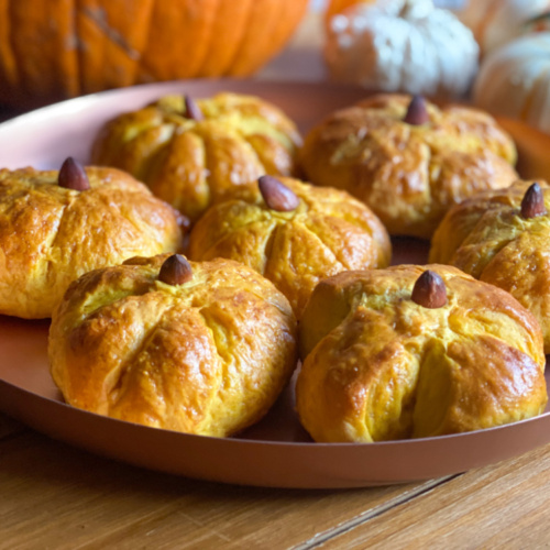 a tray with pumpkin dinner rolls