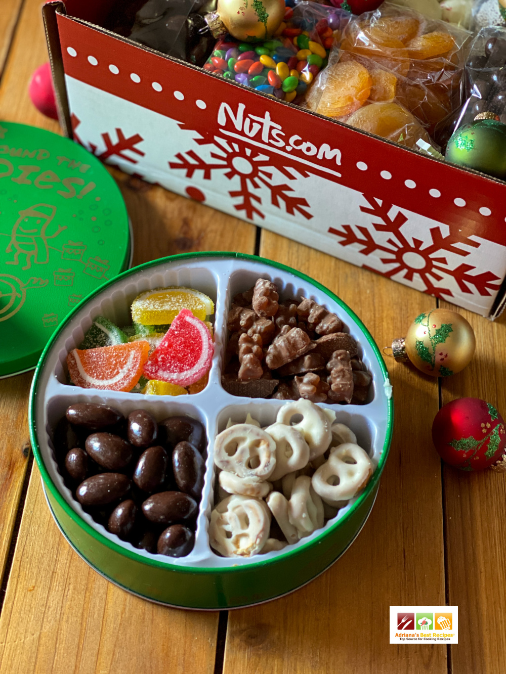 A holiday tin with nuts pretzels and gummies