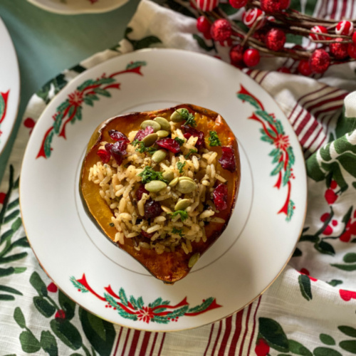 vegetarian stuffed acorn squash with wild rice served on a holiday plate