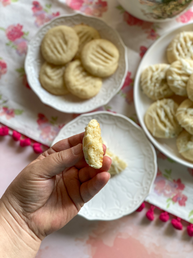 A hand showing the tenderness of a butter cookie