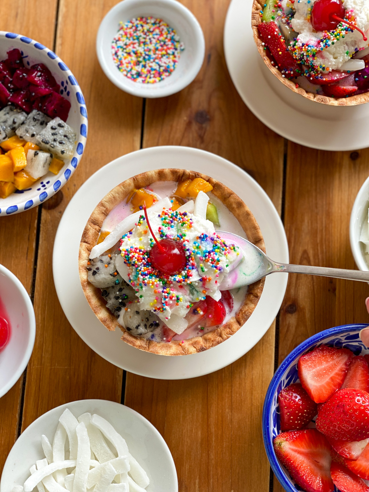 Mexican-style ice cream and a spoonful of ice cream with whipped cream, nonpareils, and a cherry