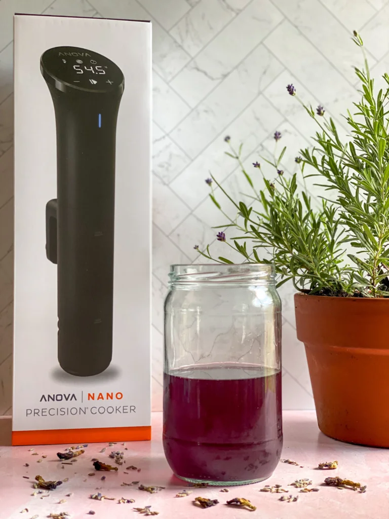 A mason jar with culinary lavender syrup and the Anova Precision Cooker Nano